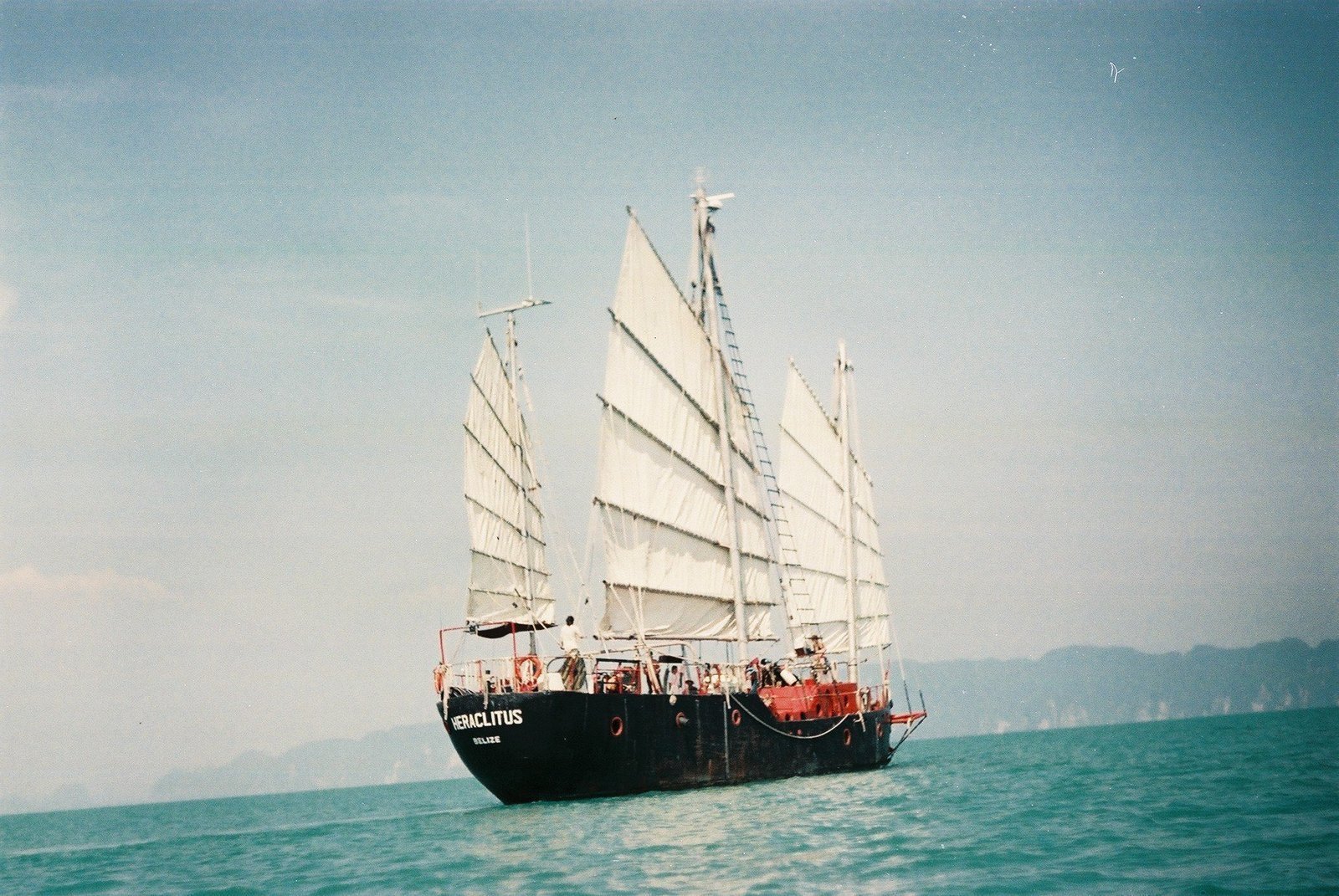 The Heraclitus under junk rig sail on open water.