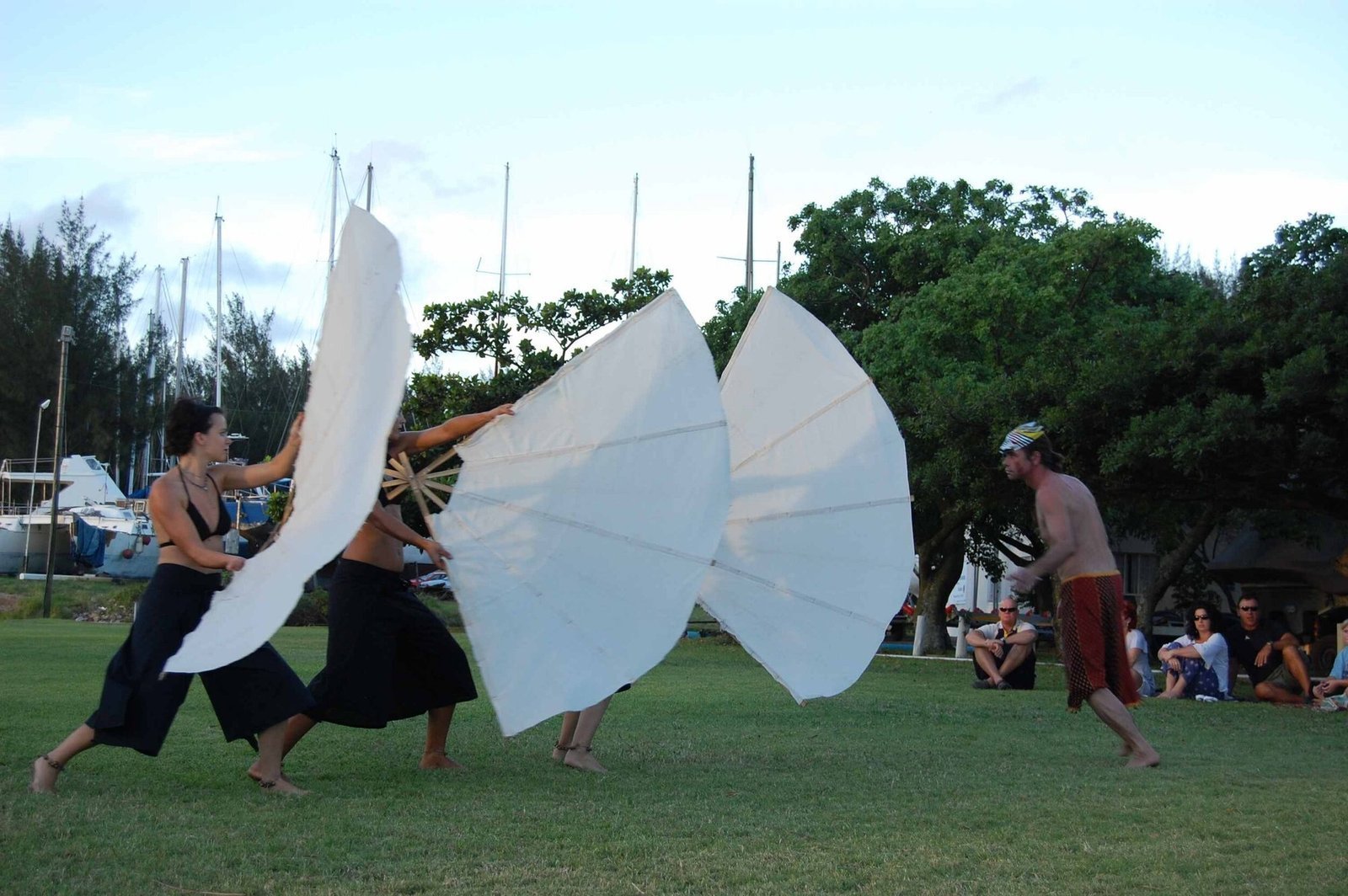 Crew of the Heraclitus performing on deck under sail.