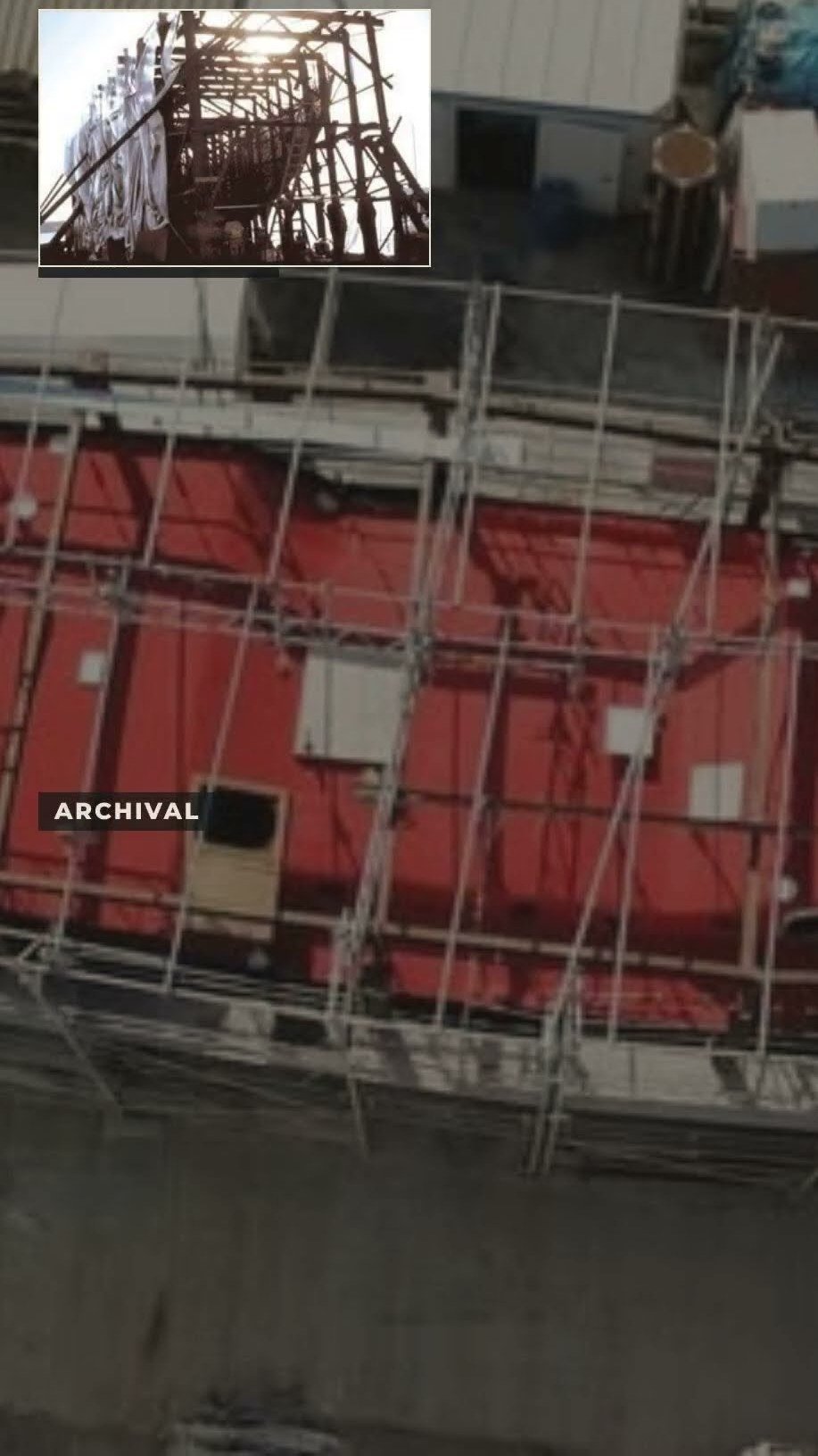 Still from episode 10, Students Build Hull Three — the red hull in its scaffolding at the shipyard, with an archival inset photograph